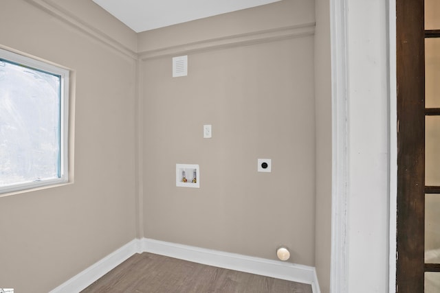 washroom with hookup for an electric dryer, hardwood / wood-style floors, and washer hookup