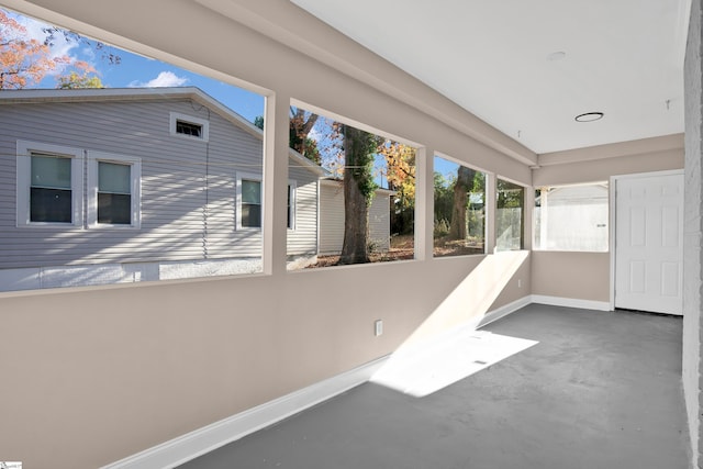 unfurnished sunroom with lofted ceiling