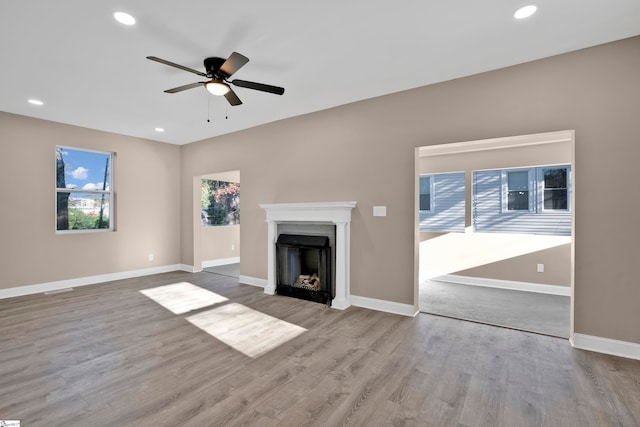 unfurnished living room featuring ceiling fan and light hardwood / wood-style flooring