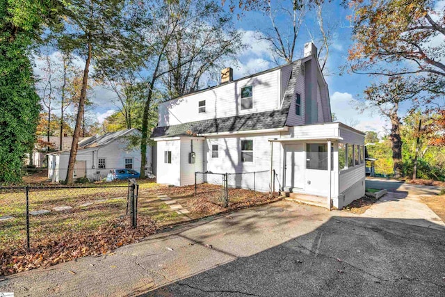 view of front of house featuring a sunroom