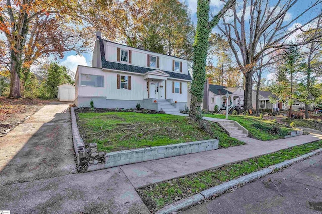 view of front of property featuring an outdoor structure and a garage