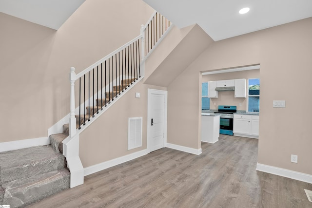 staircase featuring wood-type flooring