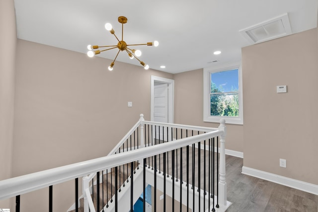 hallway featuring hardwood / wood-style floors and a notable chandelier