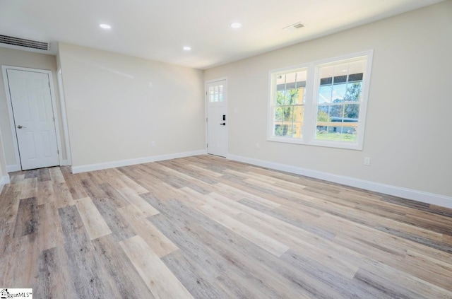 empty room with light hardwood / wood-style floors