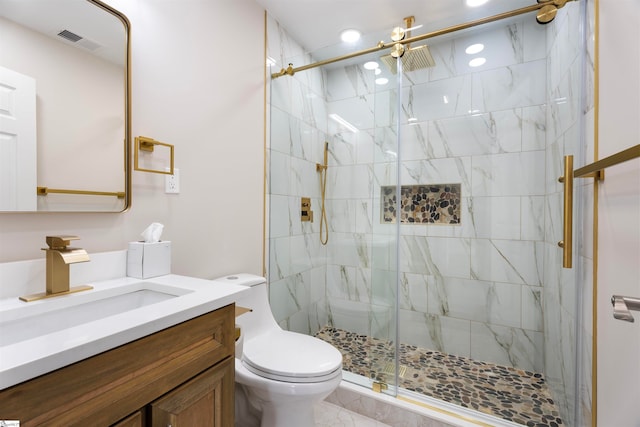 bathroom with vanity, toilet, and a shower with shower door