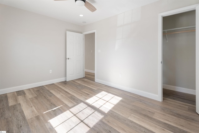 unfurnished bedroom with ceiling fan, a closet, and light hardwood / wood-style floors