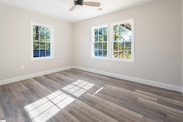 unfurnished room featuring wood-type flooring, ceiling fan, and a healthy amount of sunlight