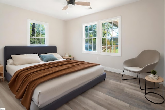 bedroom with ceiling fan and light wood-type flooring