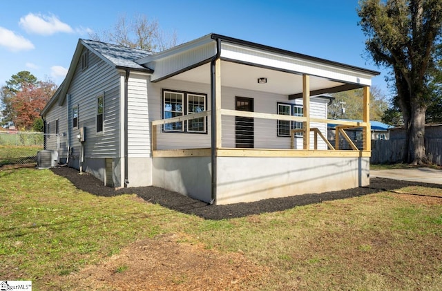 view of property exterior with a lawn and central air condition unit