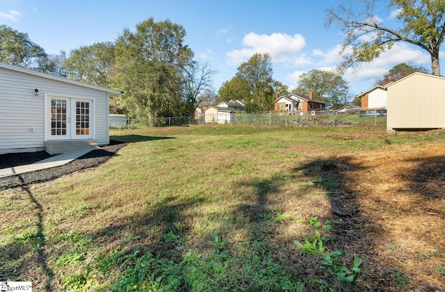 view of yard featuring french doors and a shed