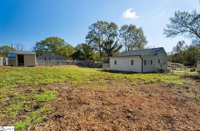 view of yard with cooling unit and a storage unit