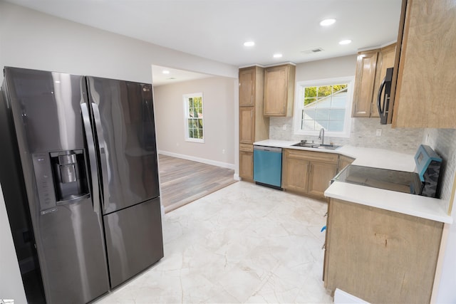 kitchen with a healthy amount of sunlight, sink, appliances with stainless steel finishes, and tasteful backsplash