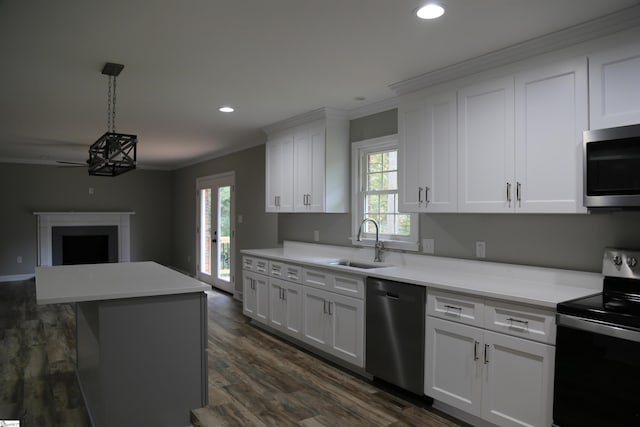 kitchen with stainless steel appliances, white cabinetry, crown molding, and sink