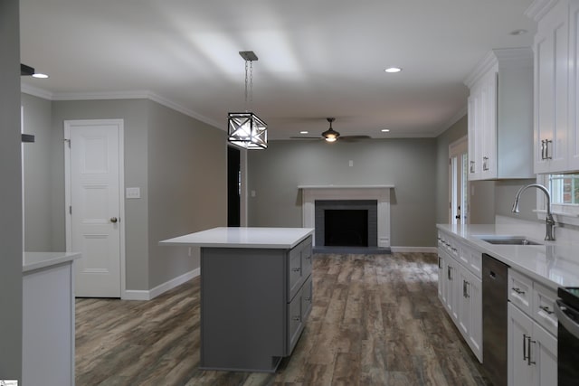 kitchen featuring dishwasher, a center island, dark hardwood / wood-style floors, a fireplace, and white cabinetry