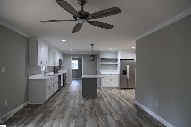 kitchen featuring white cabinets, crown molding, and appliances with stainless steel finishes