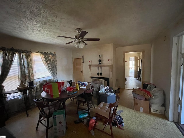 interior space with ceiling fan, a healthy amount of sunlight, and a textured ceiling