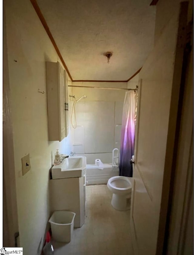 full bathroom with shower / bath combination with curtain, toilet, and sink