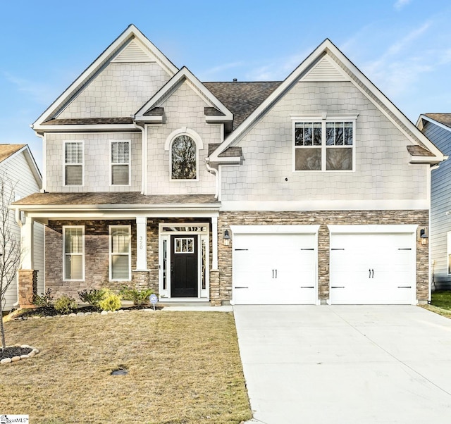 craftsman inspired home with a front yard and a garage