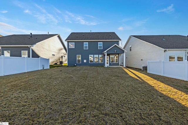 rear view of property with a lawn and central AC