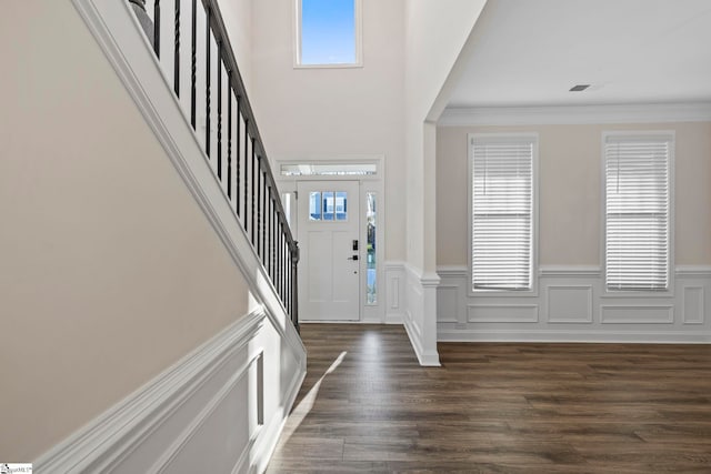 foyer entrance featuring dark hardwood / wood-style floors and crown molding