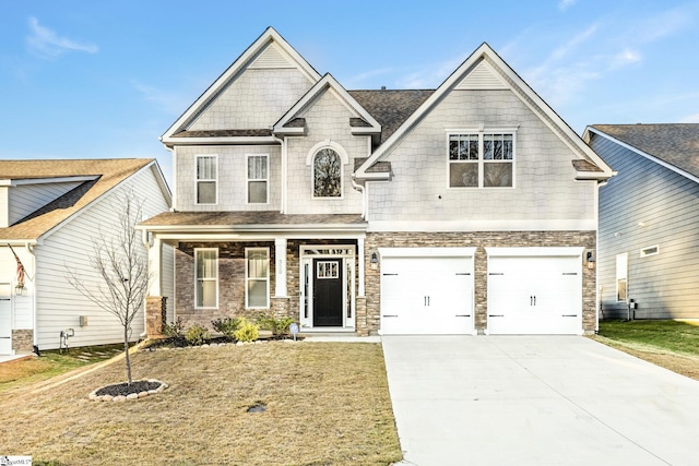 craftsman house with a front yard and a garage