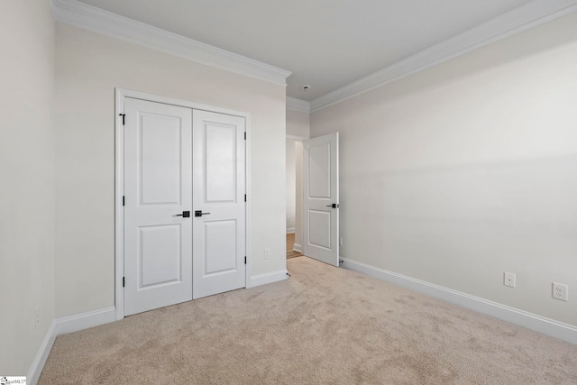 unfurnished bedroom with light carpet, a closet, and ornamental molding