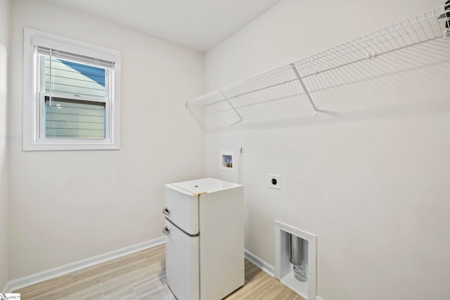 laundry room featuring hookup for an electric dryer, washer hookup, and light wood-type flooring