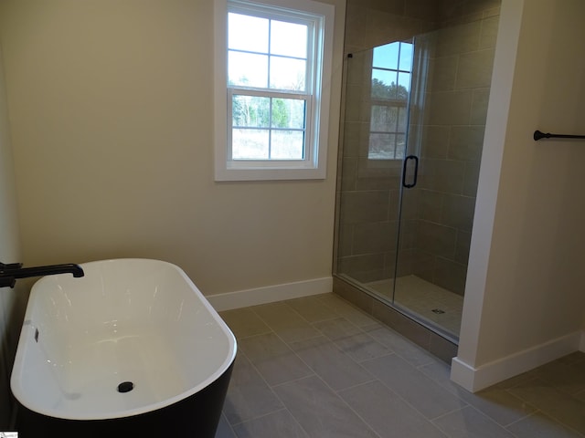 bathroom with tile patterned flooring, independent shower and bath, and sink