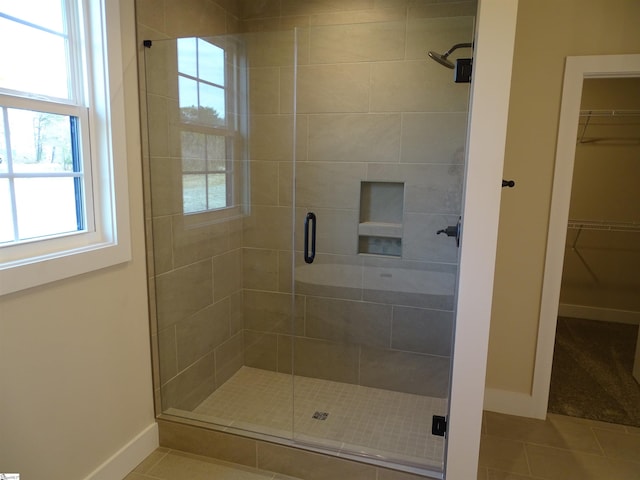 bathroom with tile patterned floors and walk in shower