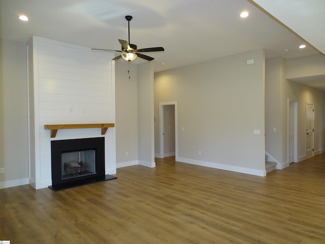 unfurnished living room with ceiling fan and hardwood / wood-style flooring