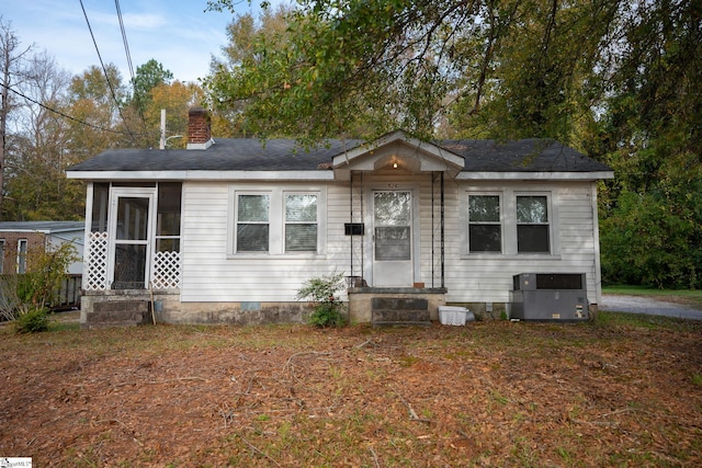 view of front of home featuring central air condition unit and a sunroom