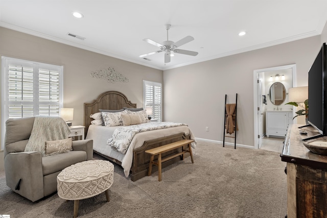 carpeted bedroom featuring connected bathroom, multiple windows, ceiling fan, and ornamental molding