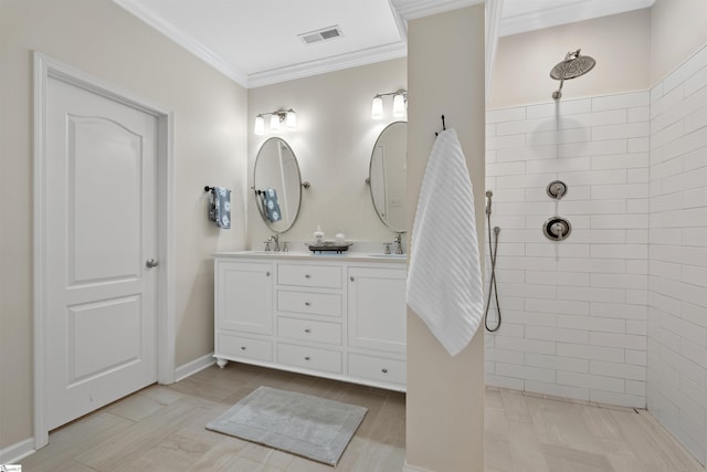 bathroom featuring crown molding, vanity, and tiled shower