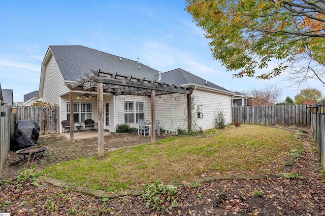 back of house featuring a yard, a pergola, and a patio area