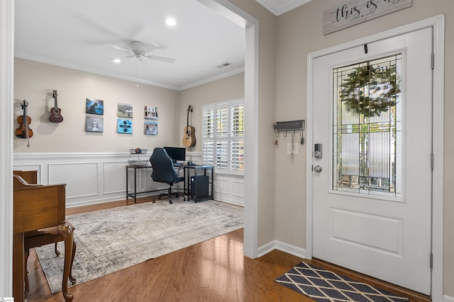 office space with wood-type flooring, ceiling fan, and ornamental molding