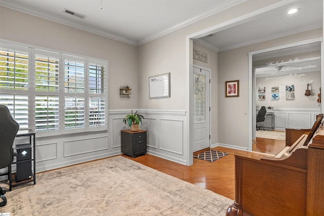 office area with ornamental molding and light wood-type flooring