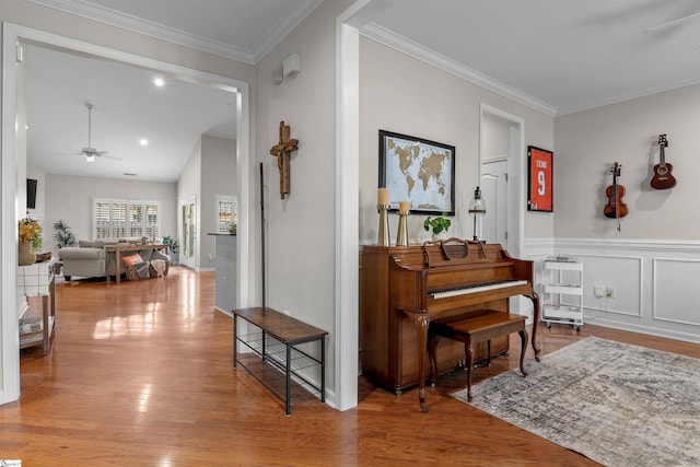 interior space featuring ceiling fan, ornamental molding, and hardwood / wood-style flooring