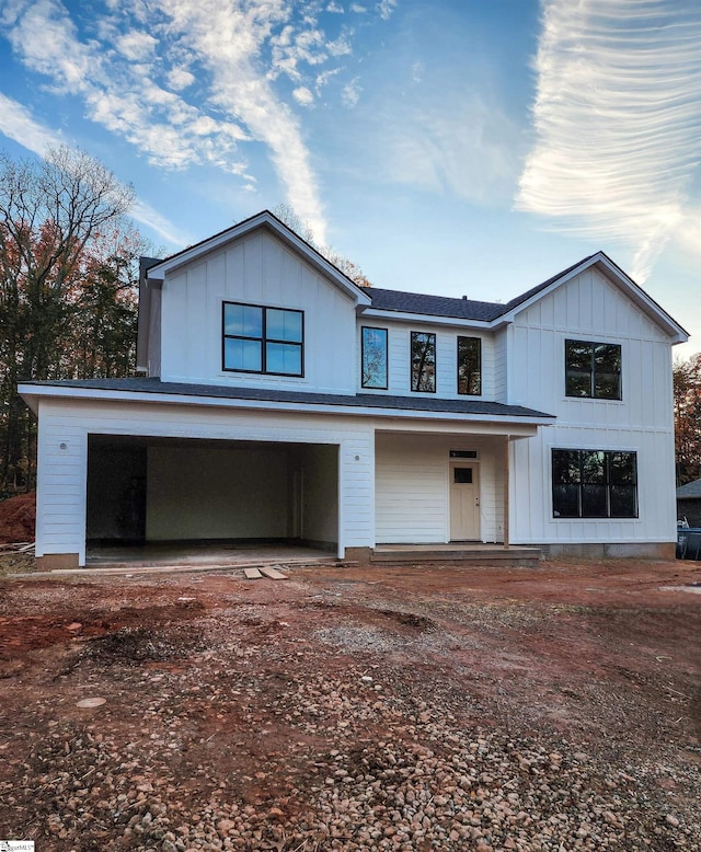 view of front of house featuring a porch and a garage