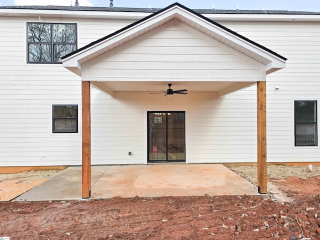 rear view of house with ceiling fan and a patio area