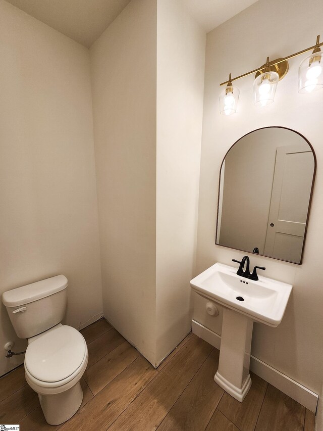 bathroom featuring hardwood / wood-style floors and toilet