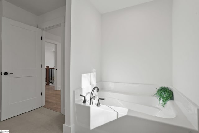 bathroom featuring tile patterned floors and a tub