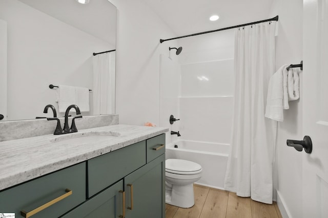 full bathroom with hardwood / wood-style flooring, vanity, toilet, and shower / bath combo