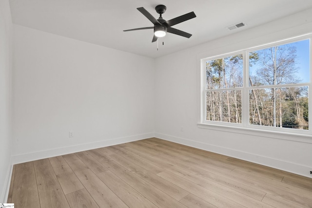 spare room with ceiling fan and light wood-type flooring