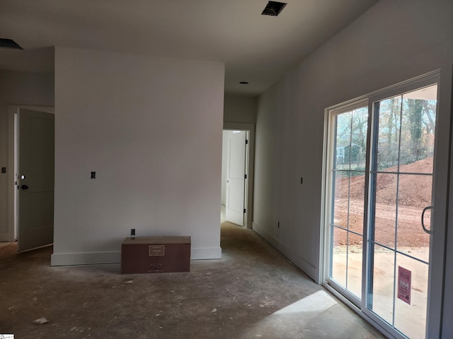 spare room featuring concrete flooring