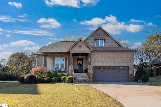 craftsman-style house with covered porch, a garage, and a front lawn