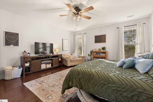 bedroom with ceiling fan and dark hardwood / wood-style floors