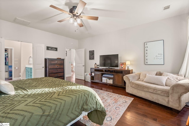 bedroom featuring ceiling fan, dark hardwood / wood-style floors, and ensuite bath