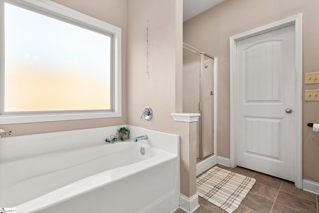 bathroom featuring shower with separate bathtub