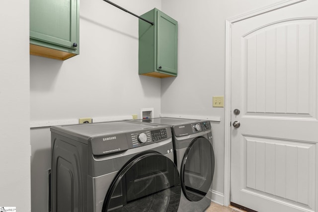 laundry area with cabinets and independent washer and dryer