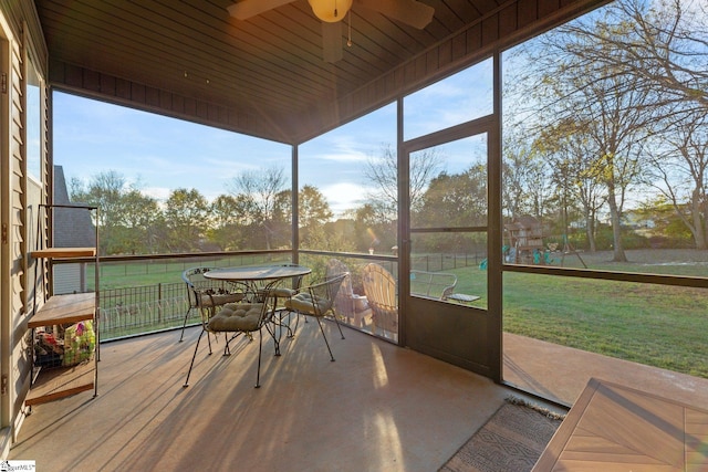 sunroom with ceiling fan and wooden ceiling